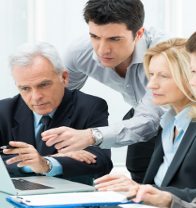 Team Of Business People Working Together On A Laptop